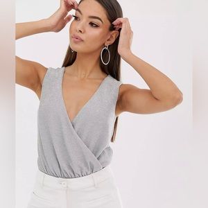 The Girlcode wrap front glitter bodysuit in silver/grey